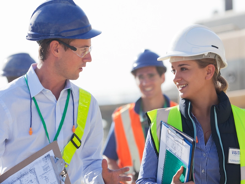 A picture of construction workers talking at a work site.